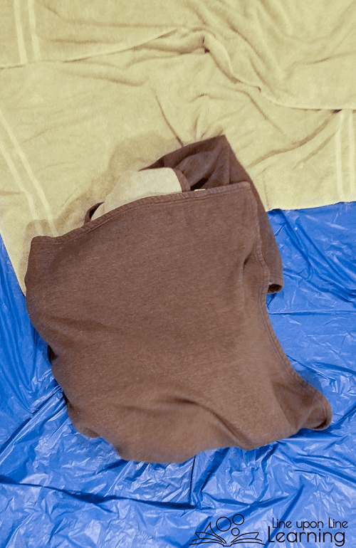 She's wrapped up in a chrysalis awaiting the moment she can burst out as a butterfly in our butterfly life cycle gross motor game. (She's getting her antennae, wings, and proboscis ready.)
