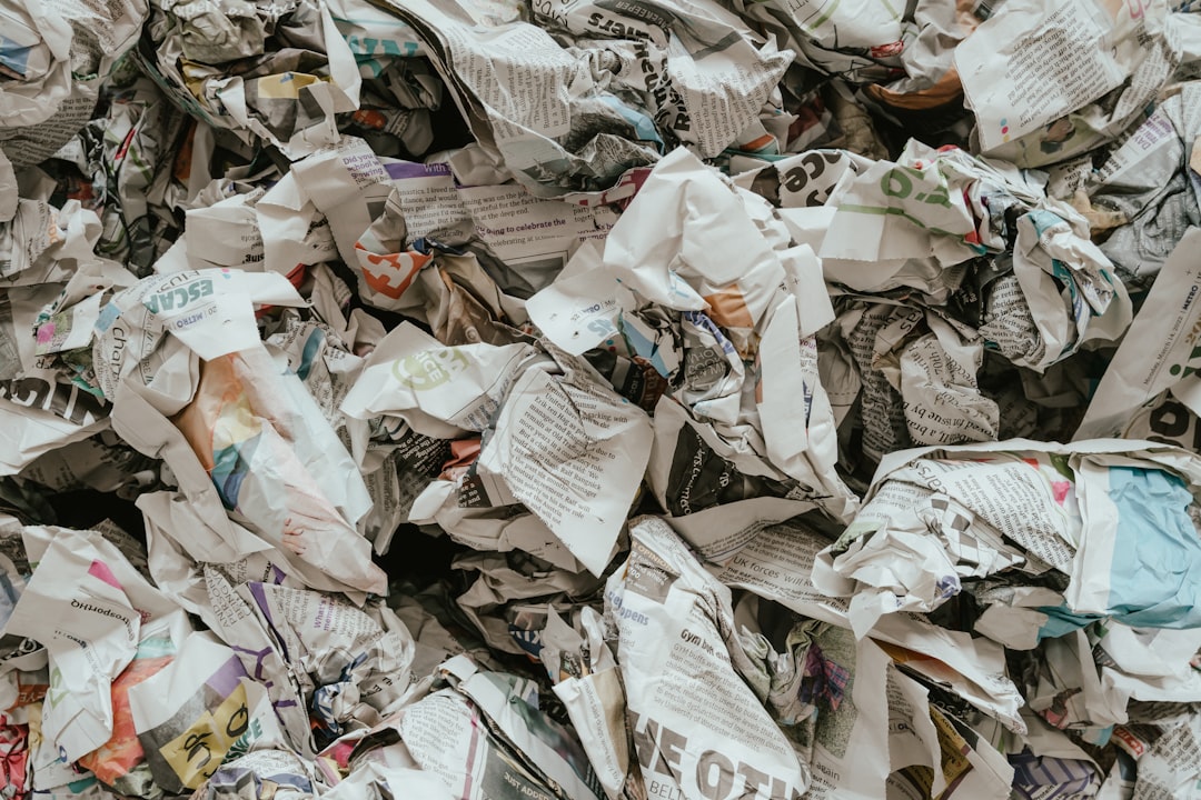 Photo by Annie Spratt a pile of newspaper with a lot of paper on top of it